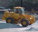 A Maryland State Highway Administration loader moves salt stored for use in winter.